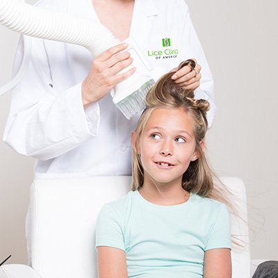 LIttle girl receiving an AirAlle treatment for head lice
